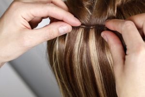 Hairstylist Applying Hair Extensions
